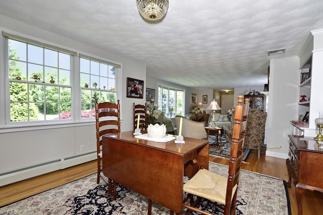 1 Butts Rock Rd, Little Compton, RI 02837 - office with wood finished floors, a baseboard heating unit, and a textured ceiling