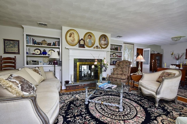 1 Butts Rock Rd, Little Compton, RI 02837 - living room with built in features, a high end fireplace, and a textured ceiling