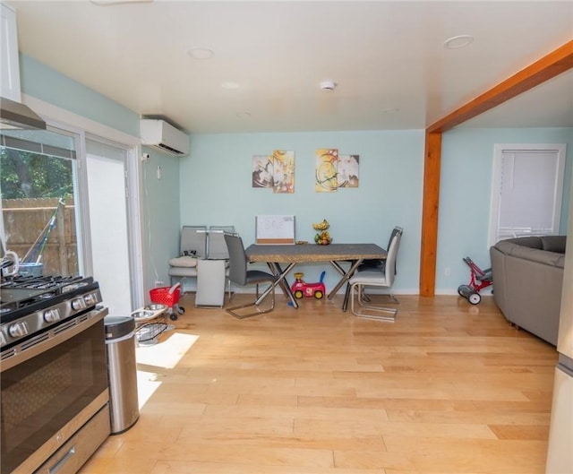 33 Williams St, New London, CT 06320 - dining area featuring a wall unit AC and wood finished floors