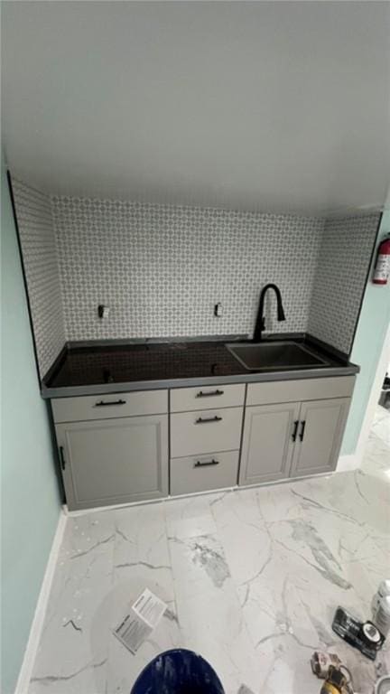 33 Williams St, New London, CT 06320 - kitchen with marble finish flooring, white cabinetry, and decorative backsplash