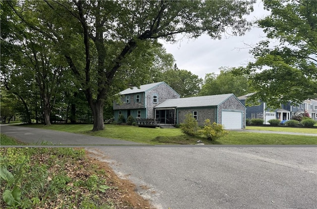 1 Grove St, Barrington, RI 02806 - view of front of home with asphalt driveway, a front yard, and an attached garage