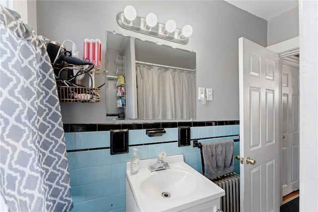 313 Branch Ave, Providence, RI 02904 - full bathroom featuring radiator, vanity, a wainscoted wall, and tile walls
