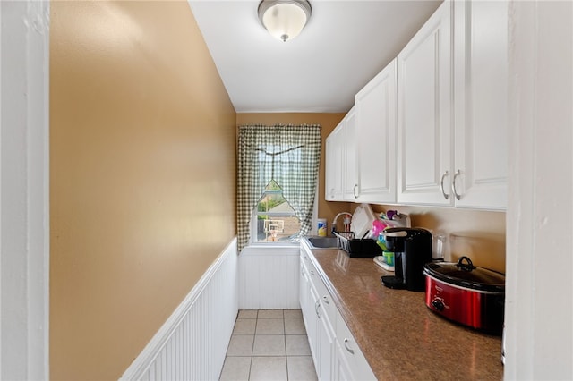 313 Branch Ave, Providence, RI 02904 - laundry room with wainscoting and light tile patterned floors
