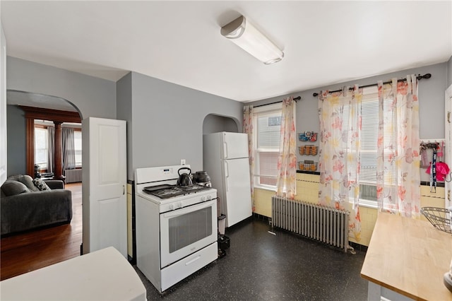 313 Branch Ave, Providence, RI 02904 - kitchen featuring white appliances, radiator, arched walkways, and healthy amount of natural light