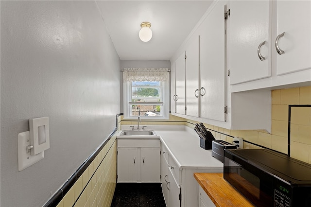 313 Branch Ave, Providence, RI 02904 - kitchen featuring black microwave, white cabinets, light countertops, and wainscoting