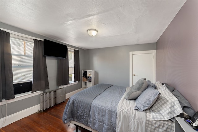 313 Branch Ave, Providence, RI 02904 - bedroom with radiator, wood finished floors, and a textured ceiling