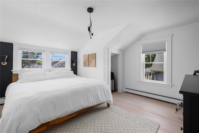 110 Spofford Ave, Warwick, RI 02888 - bedroom featuring a baseboard radiator, vaulted ceiling, and wood finished floors
