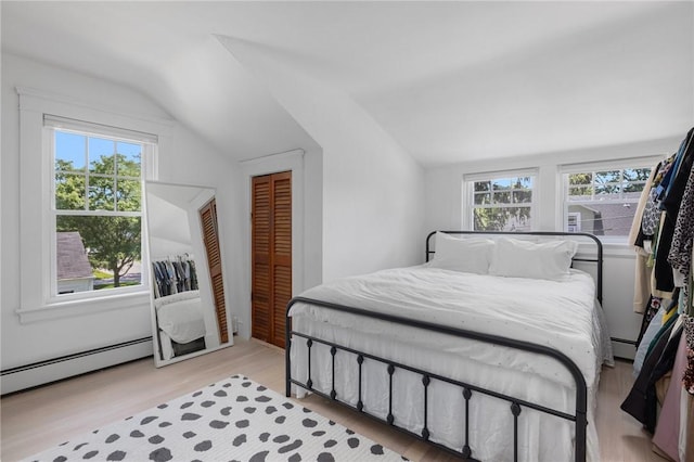 110 Spofford Ave, Warwick, RI 02888 - bedroom with vaulted ceiling, a baseboard radiator, and light wood finished floors