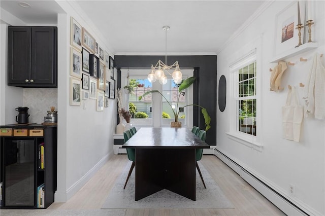 110 Spofford Ave, Warwick, RI 02888 - dining room featuring a baseboard heating unit, a chandelier, beverage cooler, light wood-type flooring, and crown molding