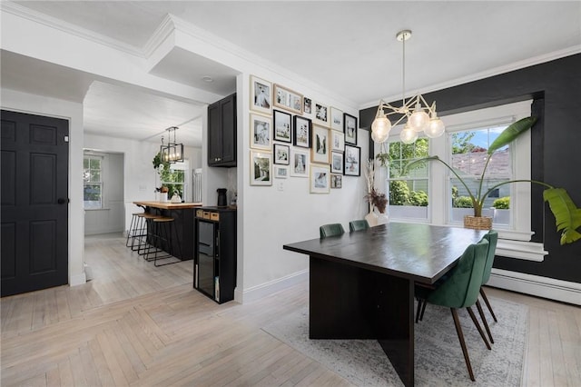 110 Spofford Ave, Warwick, RI 02888 - dining room with a chandelier, a baseboard radiator, and ornamental molding