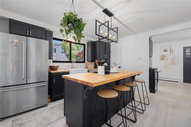 110 Spofford Ave, Warwick, RI 02888 - kitchen featuring high end refrigerator, a baseboard radiator, butcher block counters, a breakfast bar area, and pendant lighting