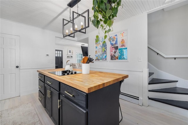 110 Spofford Ave, Warwick, RI 02888 - kitchen with wooden counters, dark cabinetry, light wood finished floors, and a chandelier