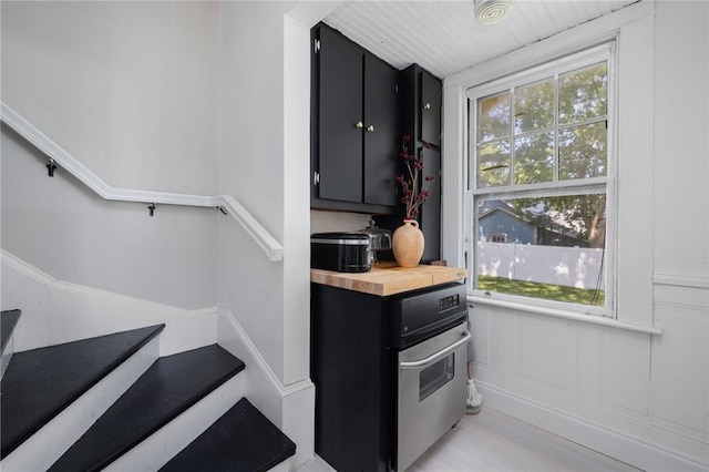 110 Spofford Ave, Warwick, RI 02888 - kitchen featuring dark cabinetry, wooden counters, and light wood-type flooring