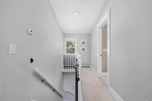 110 Spofford Ave, Warwick, RI 02888 - hallway featuring an upstairs landing, a baseboard radiator, and light wood-style flooring