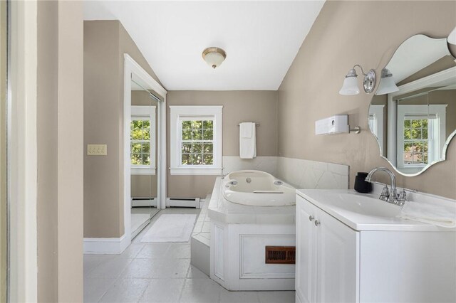 110 Spofford Ave, Warwick, RI 02888 - laundry area with healthy amount of natural light, a baseboard heating unit, and light tile patterned flooring