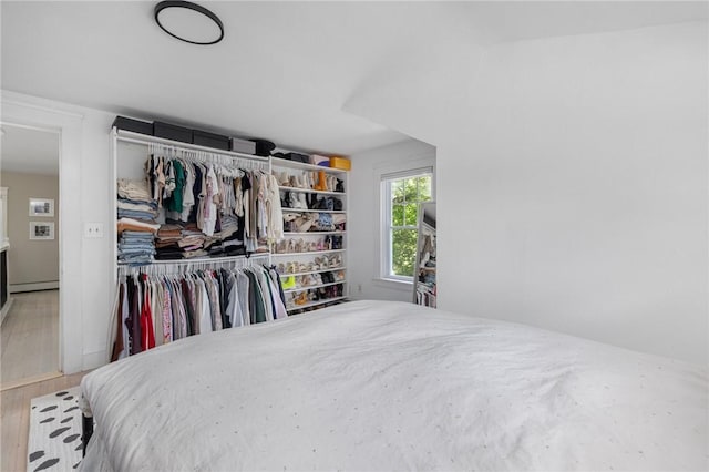 110 Spofford Ave, Warwick, RI 02888 - bedroom featuring a closet, wood finished floors, and a baseboard radiator