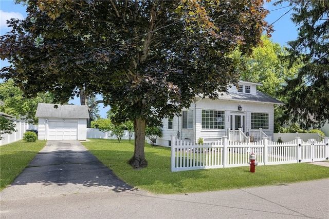 110 Spofford Ave, Warwick, RI 02888 - view of front of home featuring asphalt driveway, a fenced front yard, a garage, and an outbuilding