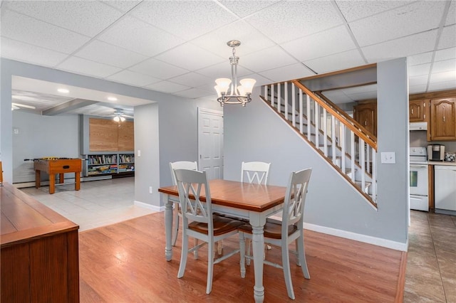 350 Shippee Rd, East Greenwich, RI 02818 - dining room with stairway, a paneled ceiling, a chandelier, and light wood finished floors