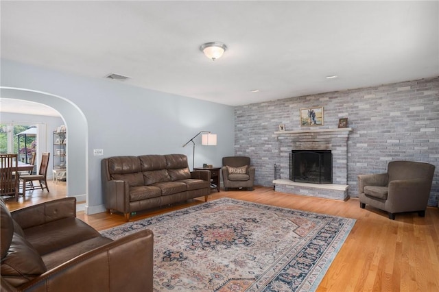 350 Shippee Rd, East Greenwich, RI 02818 - living room featuring arched walkways, wood finished floors, and a large fireplace