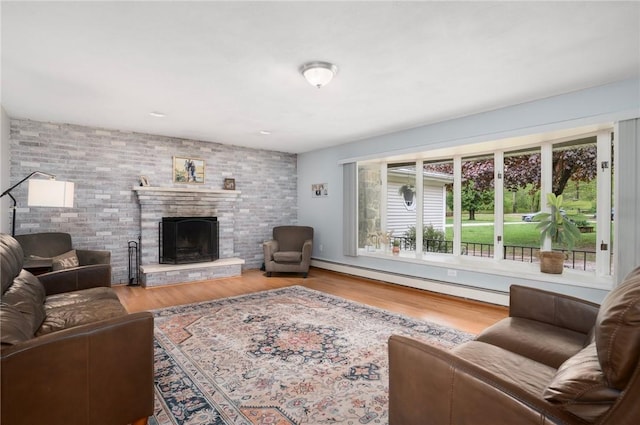 350 Shippee Rd, East Greenwich, RI 02818 - living area with a baseboard radiator, wood finished floors, and a fireplace with raised hearth