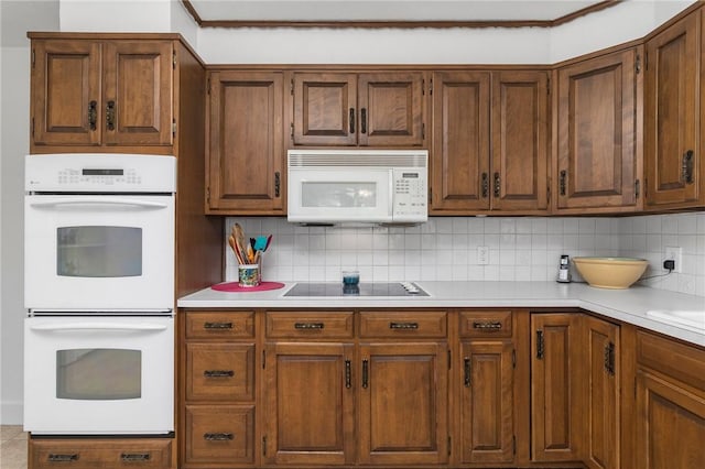 350 Shippee Rd, East Greenwich, RI 02818 - kitchen with white appliances, decorative backsplash, light countertops, and brown cabinets