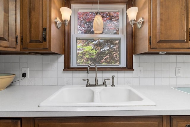 350 Shippee Rd, East Greenwich, RI 02818 - kitchen featuring light countertops, decorative backsplash, and brown cabinets