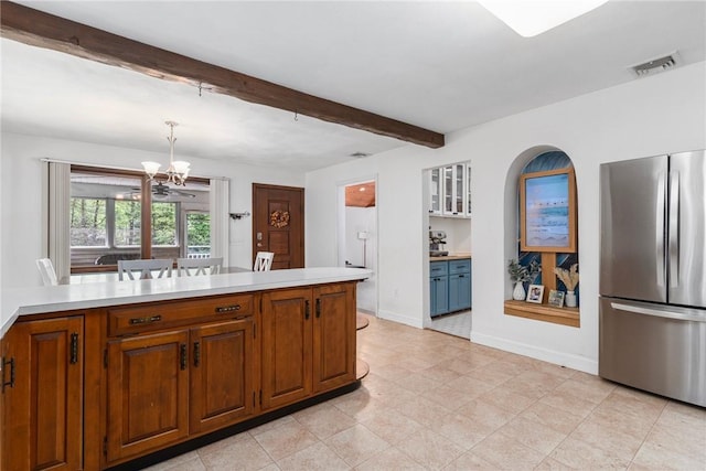 350 Shippee Rd, East Greenwich, RI 02818 - kitchen with freestanding refrigerator, a chandelier, light countertops, brown cabinetry, and beam ceiling