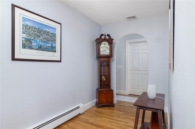 350 Shippee Rd, East Greenwich, RI 02818 - hall featuring baseboard heating, light wood-style floors, and arched walkways