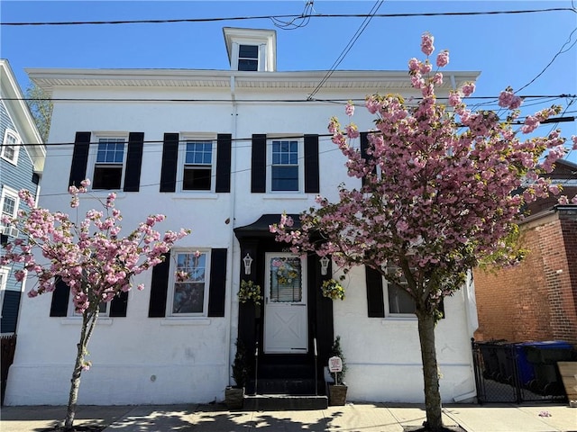 68 Grove St, Providence, RI 02909 - view of front of house with stucco siding and entry steps