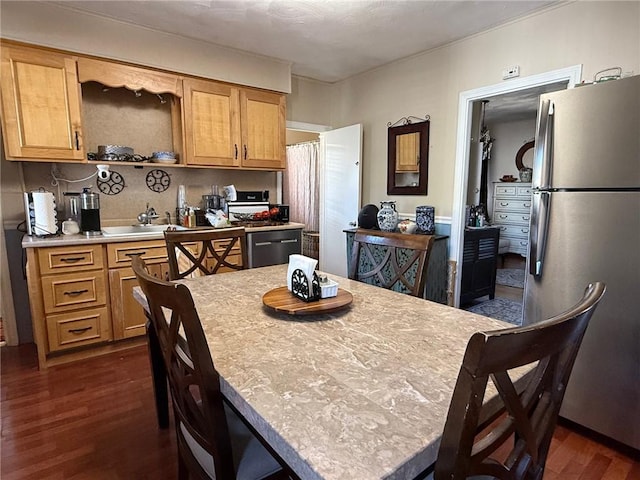 68 Grove St, Providence, RI 02909 - kitchen featuring freestanding refrigerator, dark wood-type flooring, light countertops, a center island, and a breakfast bar area