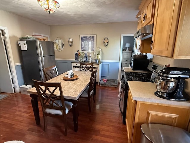 68 Grove St, Providence, RI 02909 - kitchen featuring appliances with stainless steel finishes, exhaust hood, dark wood finished floors, light countertops, and a wainscoted wall