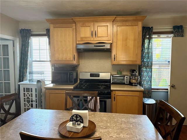 68 Grove St, Providence, RI 02909 - kitchen featuring gas stove, under cabinet range hood, black microwave, and plenty of natural light