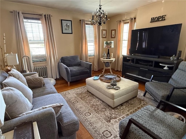 68 Grove St, Providence, RI 02909 - living room with radiator, a chandelier, healthy amount of natural light, and wood finished floors