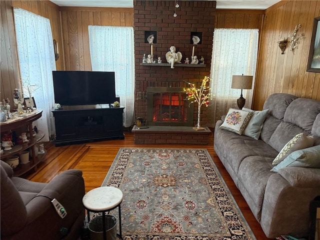 68 Grove St, Providence, RI 02909 - living area with wooden walls, wood finished floors, and a brick fireplace