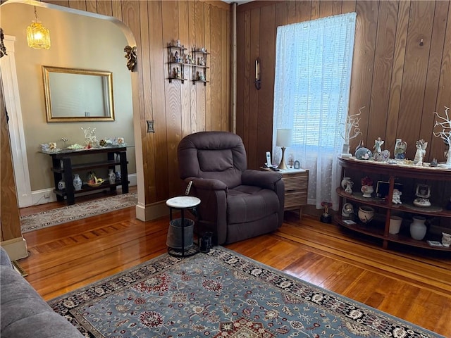 68 Grove St, Providence, RI 02909 - living area featuring hardwood / wood-style flooring, arched walkways, and wooden walls