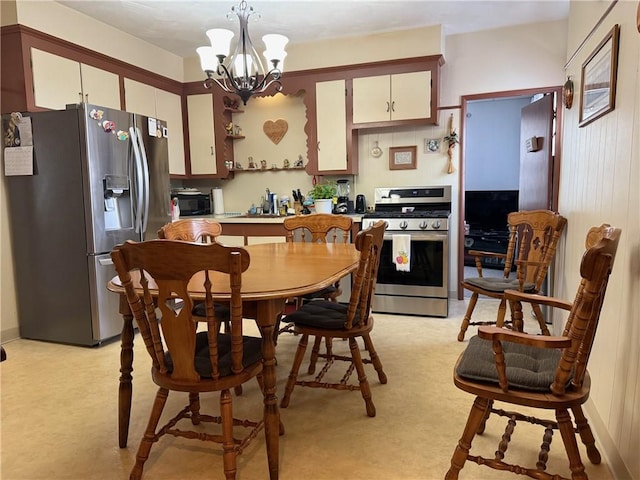 68 Grove St, Providence, RI 02909 - kitchen featuring stainless steel appliances, a chandelier, decorative light fixtures, white cabinets, and light colored carpet