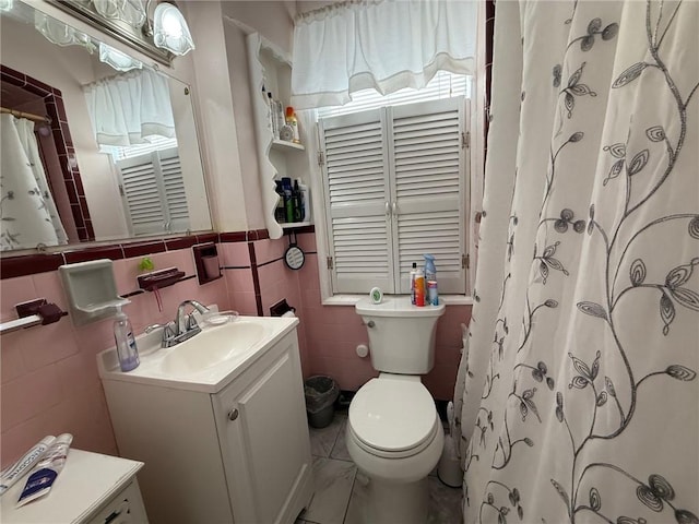 68 Grove St, Providence, RI 02909 - full bathroom with vanity, tile walls, a shower with shower curtain, and a wainscoted wall