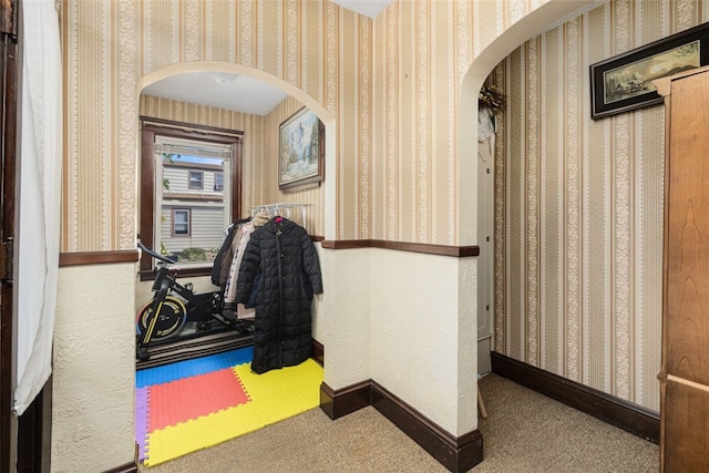 105 Overland Ave, Cranston, RI 02910 - hall featuring arched walkways, wallpapered walls, and carpet floors