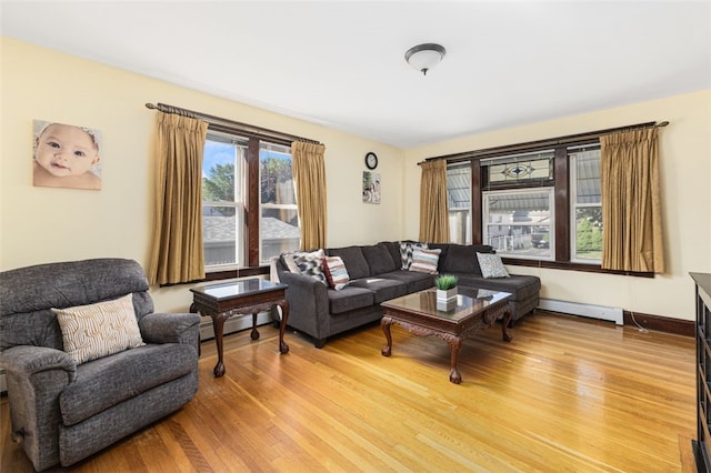 105 Overland Ave, Cranston, RI 02910 - living area with light wood-style flooring and a baseboard radiator