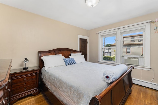 105 Overland Ave, Cranston, RI 02910 - bedroom with baseboard heating, wood finished floors, and cooling unit