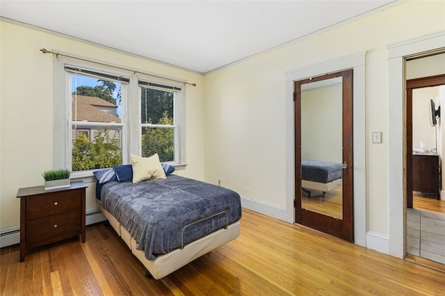 105 Overland Ave, Cranston, RI 02910 - bedroom featuring wood finished floors and a baseboard heating unit