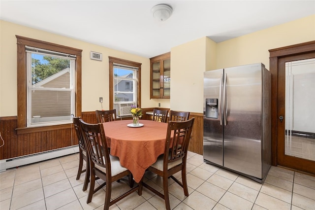 105 Overland Ave, Cranston, RI 02910 - dining area with baseboard heating, a wainscoted wall, light tile patterned floors, cooling unit, and wooden walls