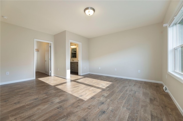 109 Chickadee Ln, South Kingstown, RI 02879 - unfurnished bedroom featuring dark wood-type flooring, a walk in closet, and ensuite bathroom