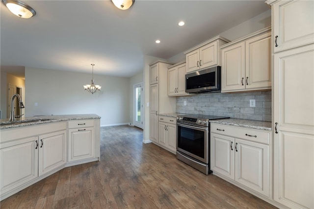 109 Chickadee Ln, South Kingstown, RI 02879 - kitchen with stainless steel appliances, decorative backsplash, recessed lighting, a chandelier, and dark wood-style floors