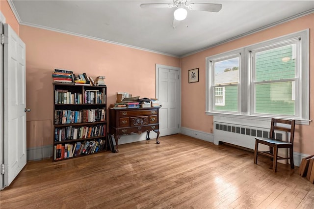 41 Higgins Ave, Providence, RI 02908 - living area featuring radiator heating unit, ceiling fan, wood finished floors, and crown molding