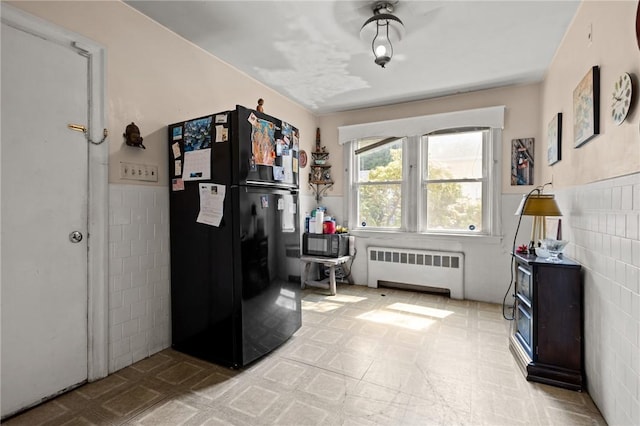 41 Higgins Ave, Providence, RI 02908 - interior space featuring radiator heating unit, freestanding refrigerator, tile walls, and a wainscoted wall