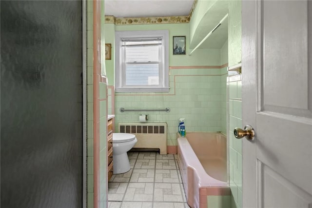 41 Higgins Ave, Providence, RI 02908 - bathroom with radiator, tile walls, a shower stall, a garden tub, and a wainscoted wall