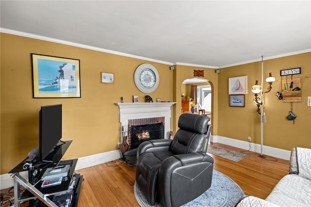 41 Higgins Ave, Providence, RI 02908 - living area featuring arched walkways, wood finished floors, ornamental molding, and a fireplace