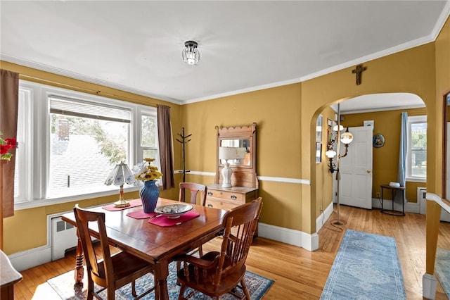 41 Higgins Ave, Providence, RI 02908 - dining room featuring arched walkways, light wood-style floors, and ornamental molding