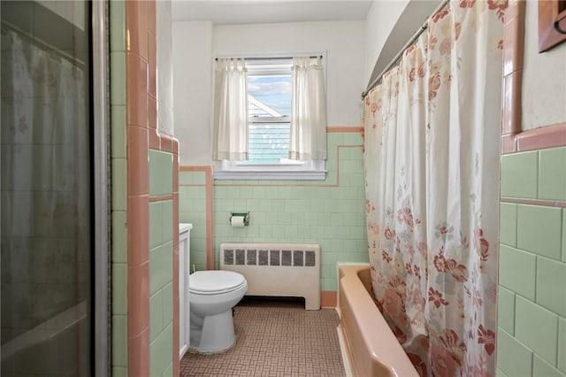 41 Higgins Ave, Providence, RI 02908 - full bath with radiator heating unit, tile walls, tile patterned flooring, wainscoting, and shower / bath combo